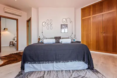 a bedroom with a bed with a black blanket at Sweett - Pedrera Department 24 in Barcelona