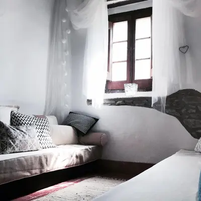 a living room with a couch and a window at Hostal Sant Roc in Montseny