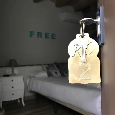 a padlock on a door in a room with a bed at Hostal Sant Roc in Montseny