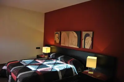 a bedroom with a bed with two lamps on it at Can Vinyals Holiday Home in Castellar
