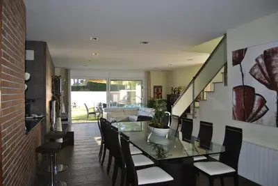a dining room with a glass table and chairs at Can Vinyals Holiday Home in Castellar
