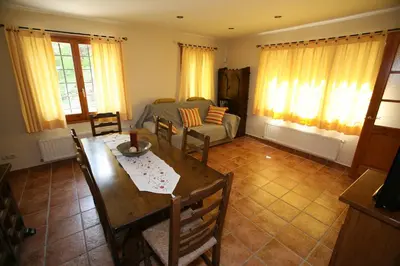 a living room with a table and a couch at Entre Roures in Moià