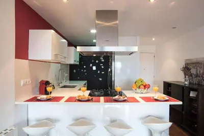 a kitchen with a counter with two plates of food on it at Vilamarlux I in Vilassar de Mar