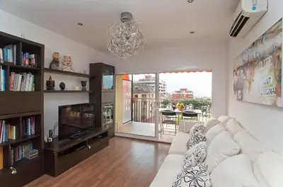 a living room with a white couch and a tv at Vilamarlux I in Vilassar de Mar