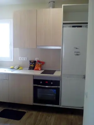 a kitchen with a refrigerator and a stove at Castel Apartments in Hospitalet de Llobregat