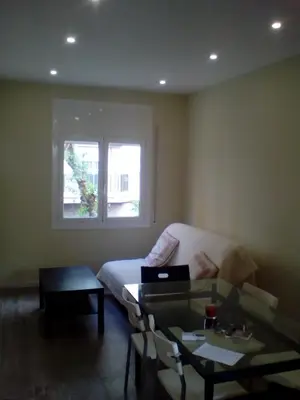 a white sink in a bathroom with a mirror at Castel Apartments in Hospitalet de Llobregat