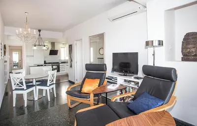 a living room with a couch and a table at The Gran Via Penthouse in Barcelona