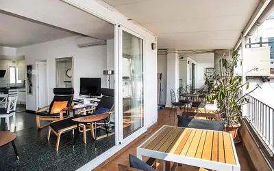 a living room with a table and chairs at The Gran Via Penthouse in Barcelona