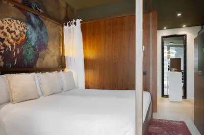 a bedroom with a canopy bed and a large window at Hotel SB Glow 4 Sup in Barcelona