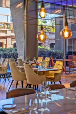 a dining room with tables and chairs and windows at Hotel SB Glow 4 Sup in Barcelona
