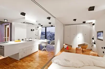 a bedroom with a bed and a bathroom with a sink at DestinationBCN Urgell Apartment in Barcelona