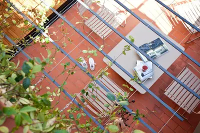 a view of a house through a fence at DestinationBCN Urgell Apartment in Barcelona