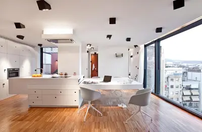 a kitchen with a desk and chairs and a large window at DestinationBCN Urgell Apartment in Barcelona