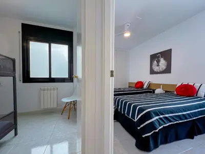 a bedroom with two beds and a window at Vivalidays Yolanda in Calella