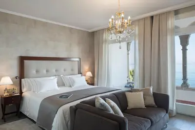 a bedroom with a large bed and a couch at Hotel Casa Vilella 4* Sup in Sitges