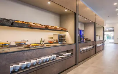 a bakery with bread and pastries on display at Hotel Venture Sant Cugat in Sant Cugat del Vallès
