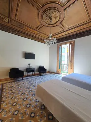 a bedroom with a bed and a coffered ceiling at Hostal Lausanne in Barcelona