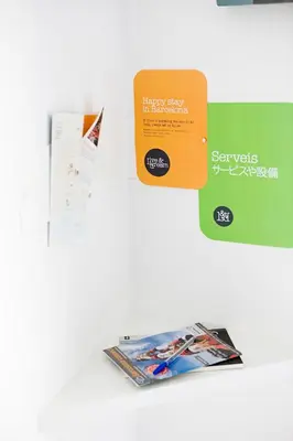 a book and a brochure on a table at Live & Dream in Barcelona