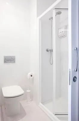 a white bathroom with a toilet and a shower at Live & Dream in Barcelona