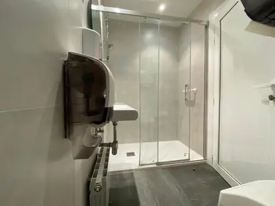 a bathroom with a shower and a sink and a toilet at Hostal BESTPRICE Barcelona Stadium in Barcelona