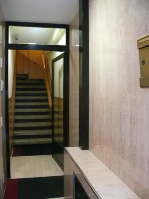 a hallway with stairs in a building with a mirror at Hostal BESTPRICE Barcelona Stadium in Barcelona