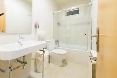 a bathroom with a sink and a toilet and a shower at Hostal BESTPRICE Barcelona Stadium in Barcelona