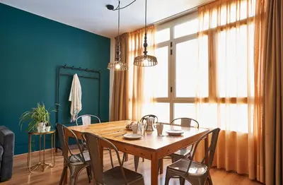 a dining room with a wooden table and chairs at Barcelona Sants Station Apartments in Barcelona