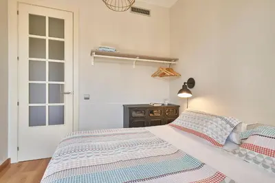 a bedroom with a bed with blue and white sheets at Barcelona Sants Station Apartments in Barcelona