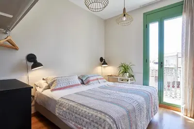 a bedroom with a bed and a large window at Barcelona Sants Station Apartments in Barcelona