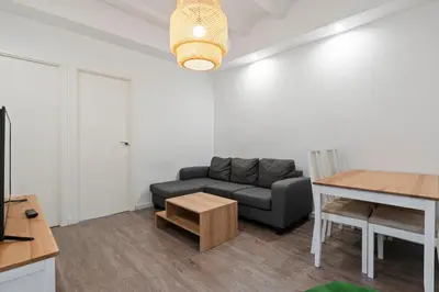 a living room with a couch and a table at Camp Nou Apartment in Hospitalet de Llobregat