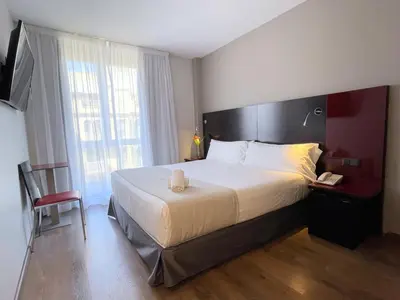 a hotel room with a large bed and a window at SM Hotel Sant Antoni in Barcelona