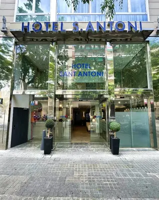 a hotel entrance with two potted plants in front of it at SM Hotel Sant Antoni in Barcelona