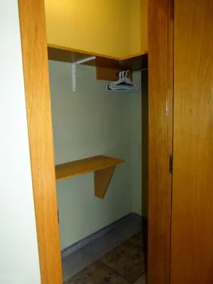 a closet with a wooden shelf in a room at Hostal Nuevo Colon in Barcelona