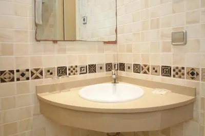 a bathroom with a sink and a mirror at Hostal Nuevo Colon in Barcelona