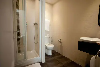 a bathroom with a toilet and a shower and a sink at Hostal Bcn 46 in Barcelona