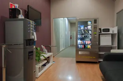 a living room with a refrigerator and a television at Hostal Bcn 46 in Barcelona
