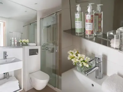 a bathroom with a toilet and a sink and a mirror at Eric Vökel Boutique Apartments - BCN Suites in Barcelona