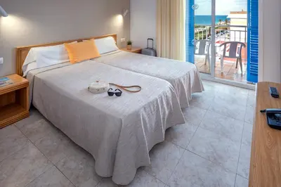 a bedroom with a bed with a view of the ocean at Hotel Sorrabona in Pineda de Mar