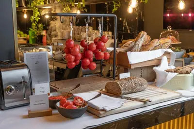 a counter with bread and grapes and other foods on it at Almanac Barcelona in Barcelona
