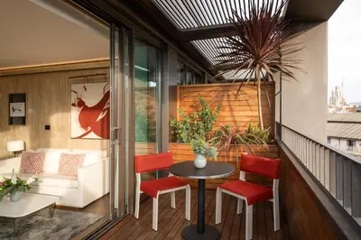 a balcony with a table and chairs and a couch at Almanac Barcelona in Barcelona