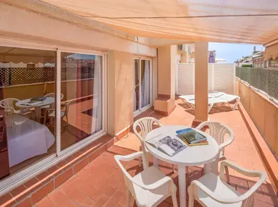 a patio with a table and chairs on a balcony at Aparthotel Bertrán in Barcelona