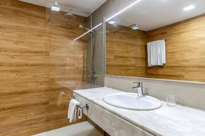 a bathroom with a sink and a shower at Aparthotel Bertrán in Barcelona