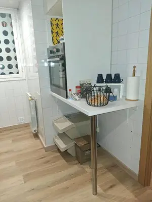 a small kitchen with a table and a microwave at Candela's Beach Port in Masnou