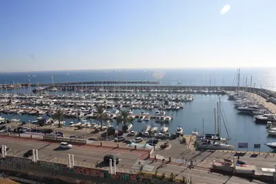 a marina filled with lots of boats in the water at Candela's Beach Port in Masnou