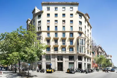 a tall white building with motorcycles parked in front of it at Fisa Rentals Shopping in Barcelona