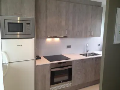 a kitchen with a white refrigerator and a microwave at Fisa Rentals Shopping in Barcelona