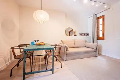 a living room with a table and a couch at Sweett - Wellington in Barcelona
