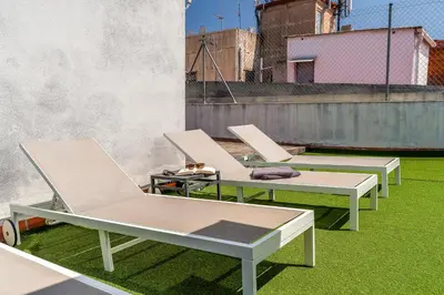 a group of chairs sitting on top of a roof at Canela Homes BARCELONA MACBA in Barcelona