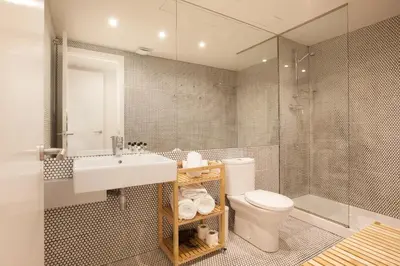 a bathroom with a toilet and a sink and a shower at Canela Homes BARCELONA MACBA in Barcelona