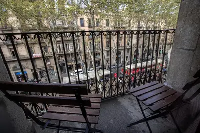 a bench on a balcony with a view of a street at Cuatro Naciones in Barcelona